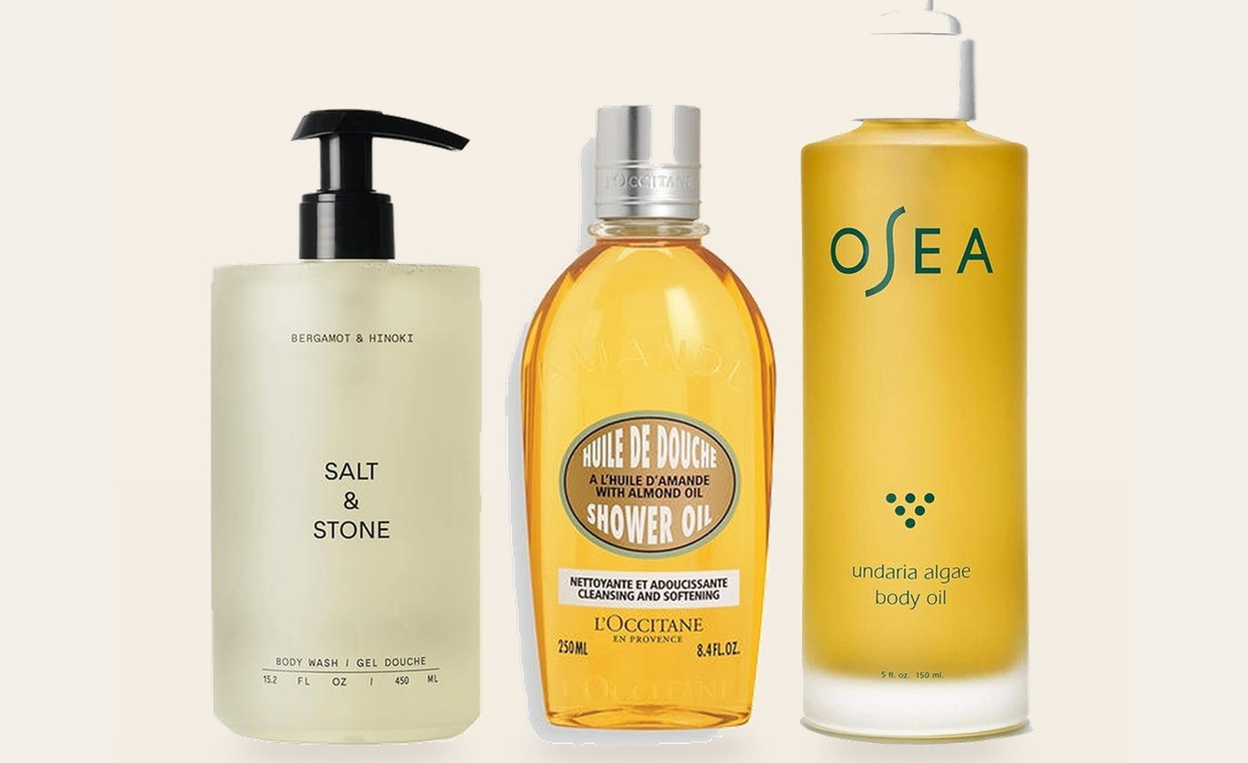 Salt & Stone body wash, L’Occitane shower oil, and OSEA body oil arranged on a cream vanity